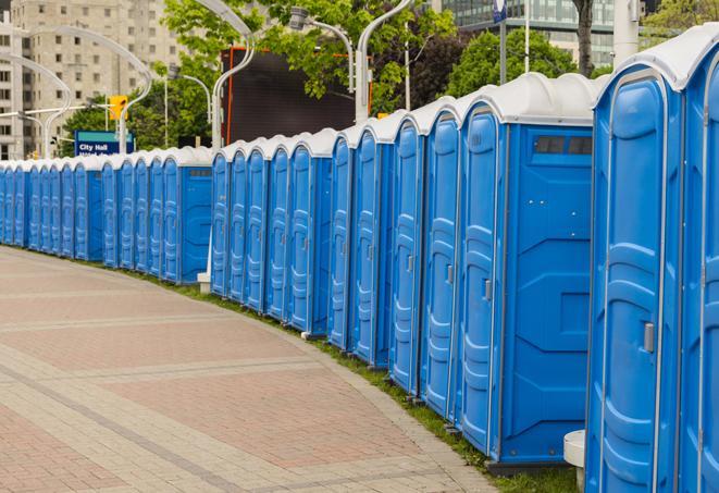 a line of portable restrooms at an outdoor wedding, catering to guests with style and comfort in Fremont NE